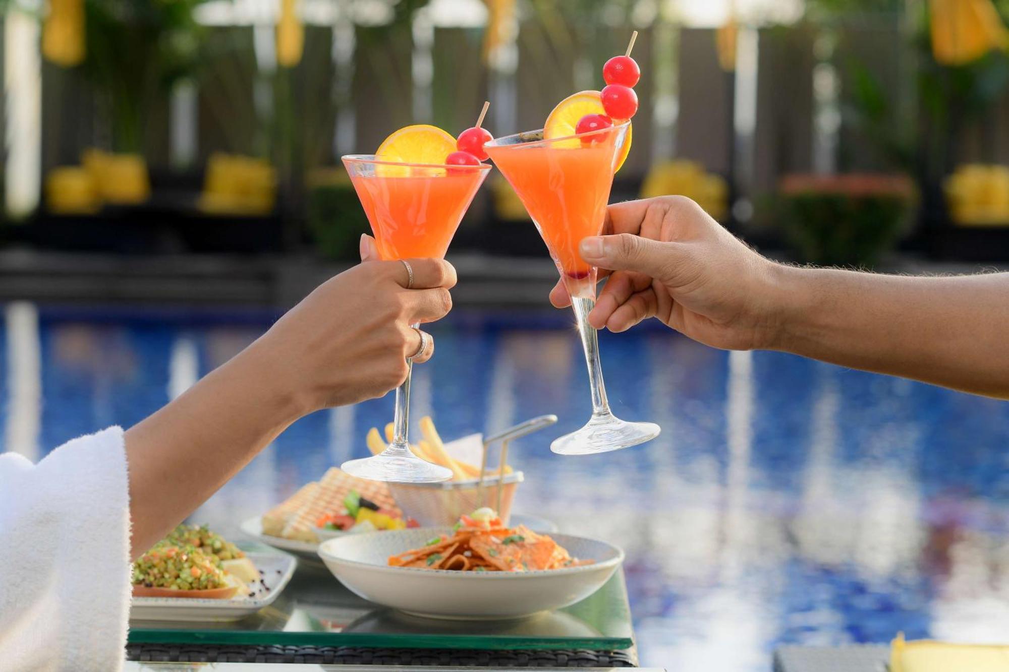 Radisson Blu Hotel Guwahati Exteriör bild A couple toasting with cocktails